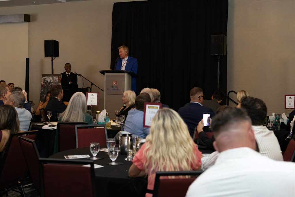 A speaker addresses guests during the gala program